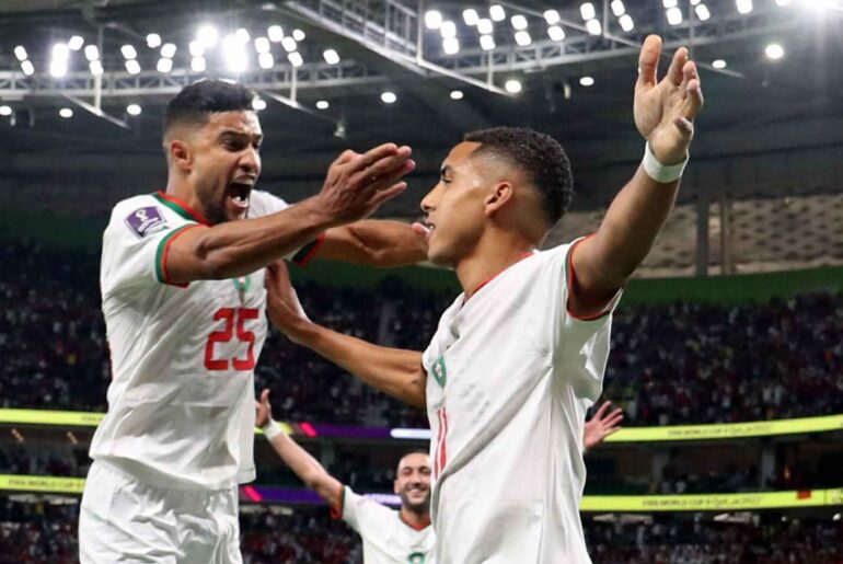 Yahia Attiyat Allah jumping to celebrate with Morocco teammate Abdelhamid Sabiri